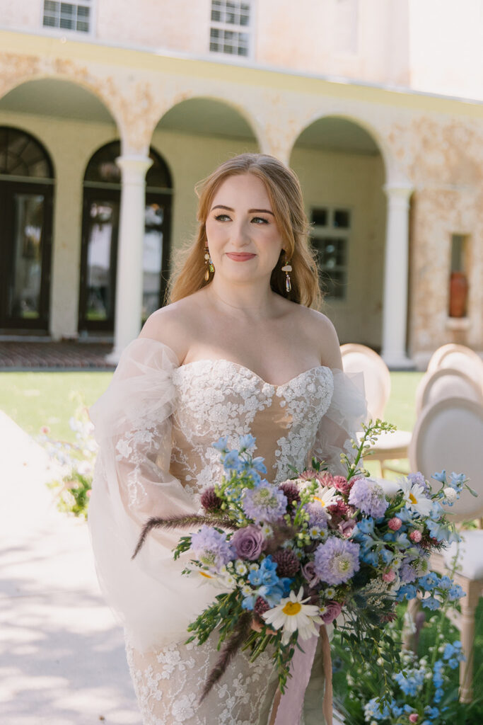 Orlando Wedding Hair and Makeup | Makeup Artist Orlando Beauty Brigade | Bride with half up half down hairstyle holding a pastel bouquet