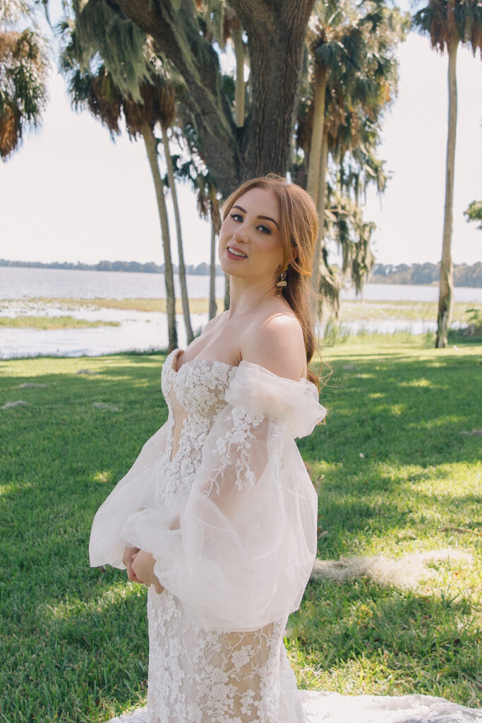 Orlando Wedding Hair and Makeup | Makeup Artist Orlando Beauty Brigade | Bride wearing an off shoulder dress with a half up half down hairstyle