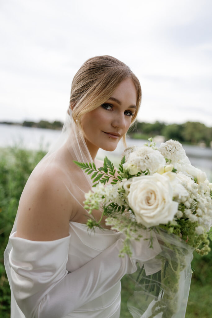 Wedding makeup artist in Orlando | Makeup Artist Orlando Beauty Brigade | Bride holding a bouquet of flowrers