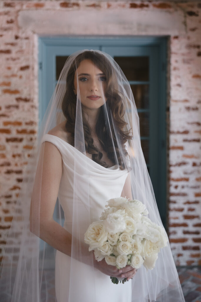 Orlando bridal hair and makeup | Makeup Artist Orlando Beauty Brigade | Bride with elegantly styled curls and red lip with a veil