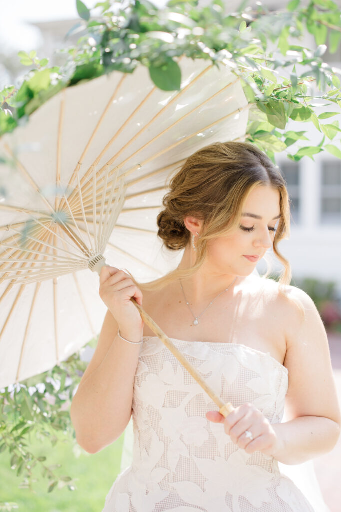 Orlando Wedding Hair and Makeup | Makeup Artist Orlando | Bride holding an umbrella with soft glam makeup and updo