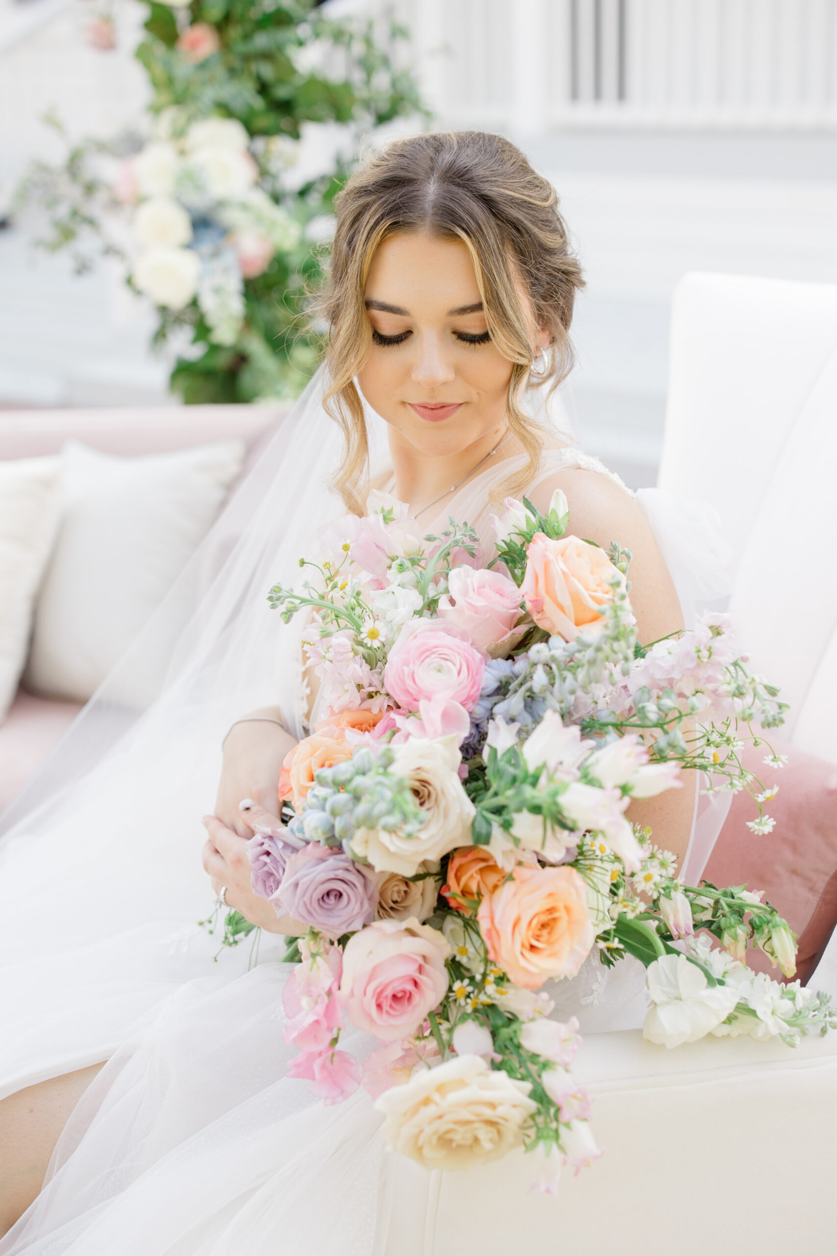 Orlando makeup bridal | Makeup Artist Orlando Beauty Brigade | Bride with a styled updo and soft glam makeup holding a bouquet