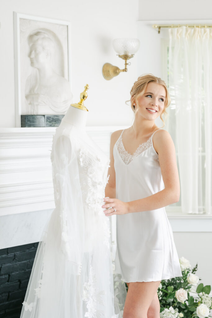 Orlando makeup artists | Makeup Artist Orlando Beauty Brigade | Bride smiling standing next to her gown