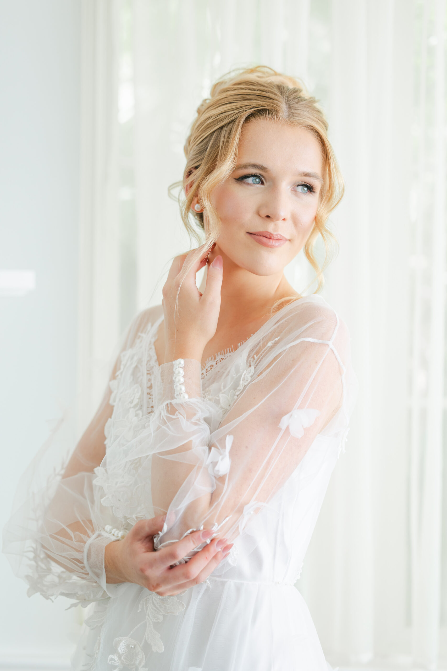 Orlando wedding hair and makeup | Makeup Artist Orlando Beauty Brigade | Bride in a robe with a styled updo and soft glam makeup